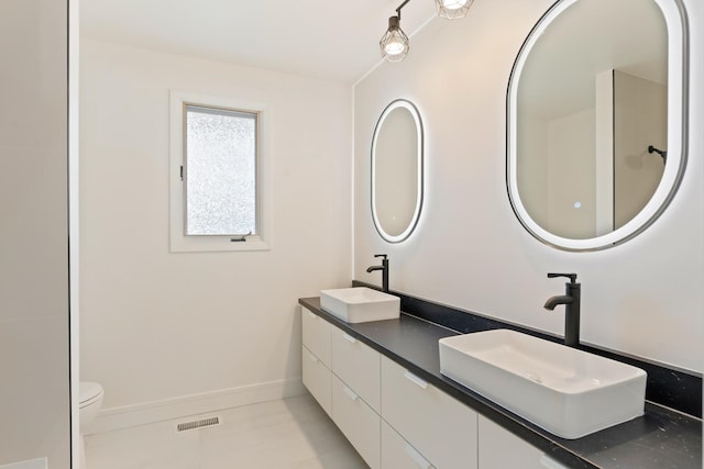 7723 W 157th St, Orland Park, IL 60462 - bathroom with double vanity, toilet, tile patterned flooring, and baseboards