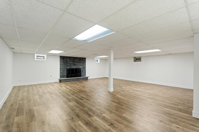 7723 W 157th St, Orland Park, IL 60462 - basement featuring a brick fireplace, wood finished floors, baseboards, and a drop ceiling