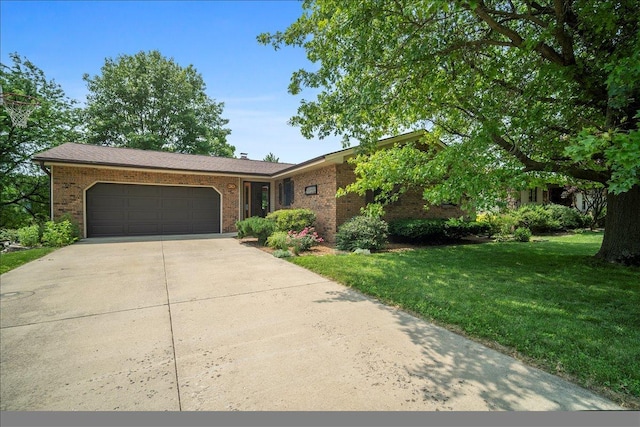 315 S Bone Dr, Normal, IL 61761 - view of front of home with brick siding, driveway, a garage, and a front lawn