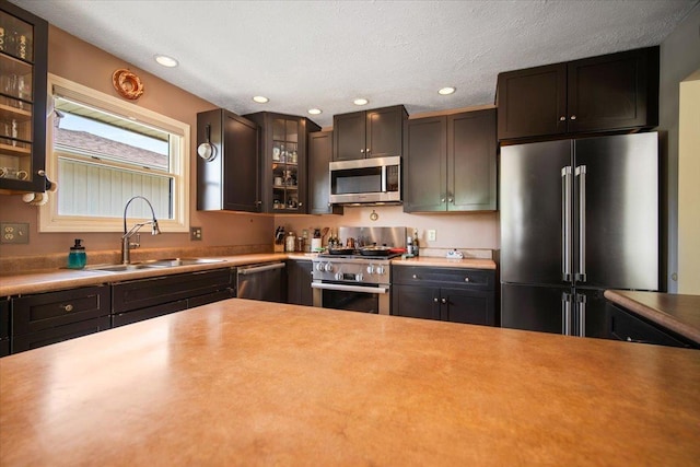 315 S Bone Dr, Normal, IL 61761 - kitchen featuring appliances with stainless steel finishes, recessed lighting, glass insert cabinets, light countertops, and a textured ceiling