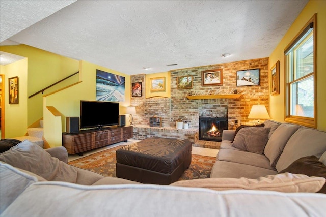 315 S Bone Dr, Normal, IL 61761 - living room with a textured ceiling, a fireplace, stairs, and brick wall