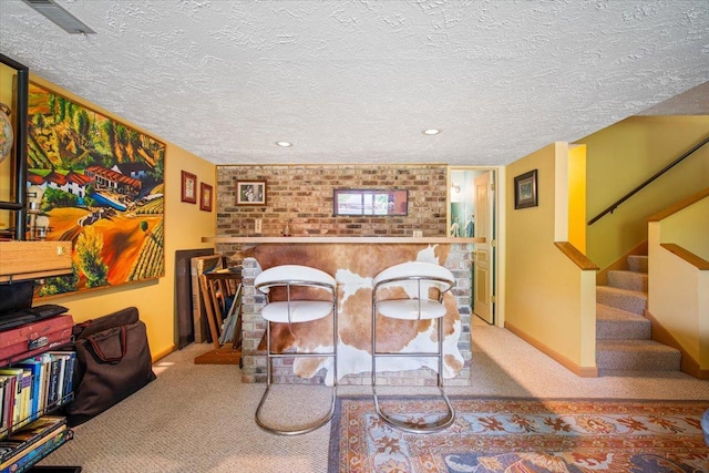 315 S Bone Dr, Normal, IL 61761 - dining room featuring brick wall, carpet, stairway, and a textured ceiling