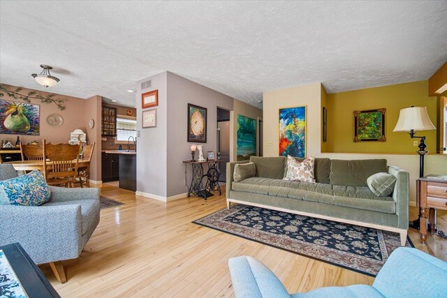 315 S Bone Dr, Normal, IL 61761 - living room featuring a textured ceiling and wood finished floors