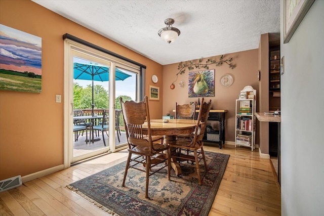 315 S Bone Dr, Normal, IL 61761 - dining space with a textured ceiling and light wood-style floors