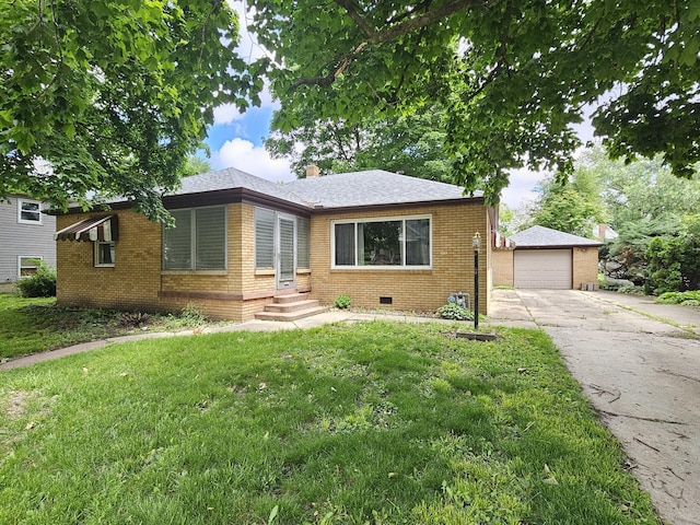 1212 N Mill St, Pontiac, IL 61764 - view of front of house featuring brick siding, concrete driveway, a garage, a front yard, and an outdoor structure