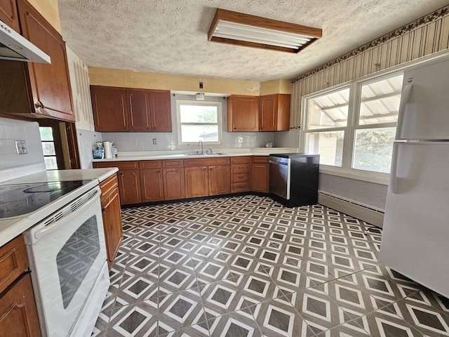 1212 N Mill St, Pontiac, IL 61764 - kitchen with white appliances, under cabinet range hood, light floors, a textured ceiling, and a baseboard heating unit