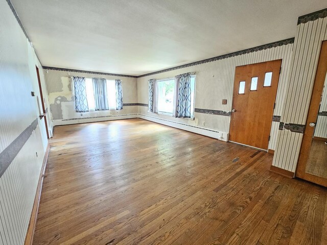 1212 N Mill St, Pontiac, IL 61764 - unfurnished living room with wood finished floors and a baseboard radiator