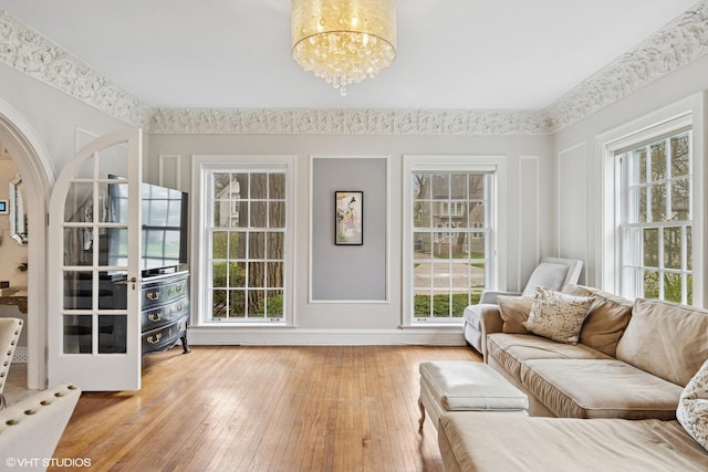 1025 Sheridan Rd, Wilmette, IL 60091 - living room featuring plenty of natural light, a chandelier, hardwood / wood-style floors, and arched walkways