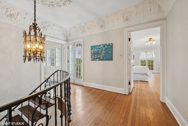 1025 Sheridan Rd, Wilmette, IL 60091 - hallway featuring baseboards, a textured wall, a chandelier, and light wood-style flooring