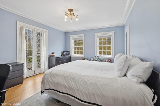 1025 Sheridan Rd, Wilmette, IL 60091 - bedroom with ornamental molding, light wood-type flooring, access to exterior, and a chandelier