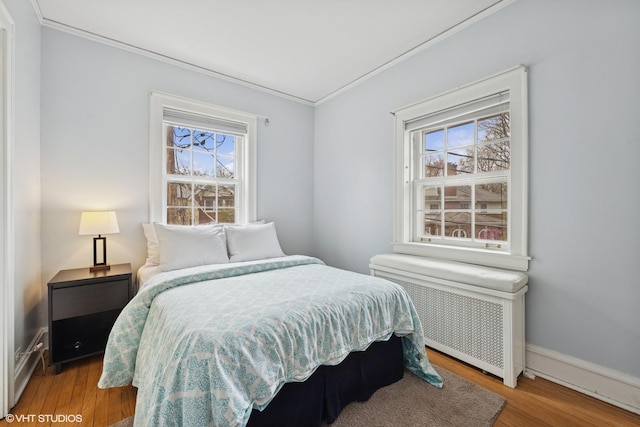 1025 Sheridan Rd, Wilmette, IL 60091 - bedroom with radiator heating unit, ornamental molding, wood finished floors, and baseboards