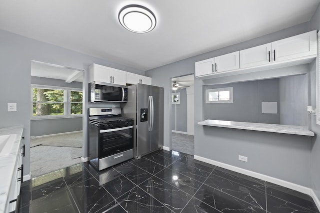 15603 Park Ln, South Holland, IL 60473 - kitchen featuring stainless steel appliances, baseboards, white cabinetry, dark marble finish flooring, and healthy amount of natural light