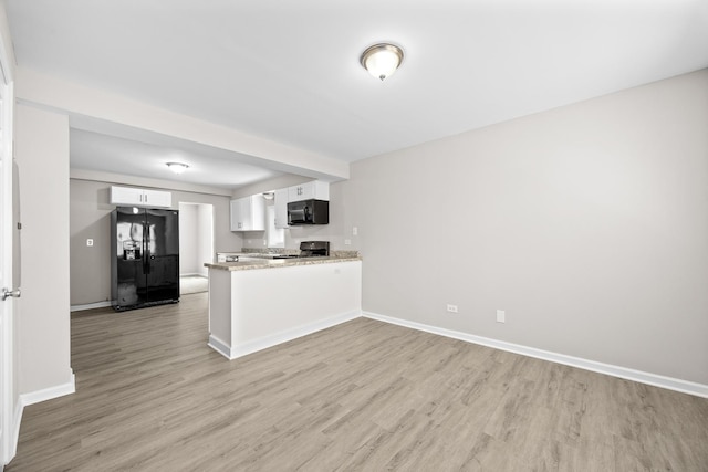 4117 W 99th St, Oak Lawn, IL 60453 - kitchen with black appliances, light wood-style floors, white cabinetry, baseboards, and a peninsula