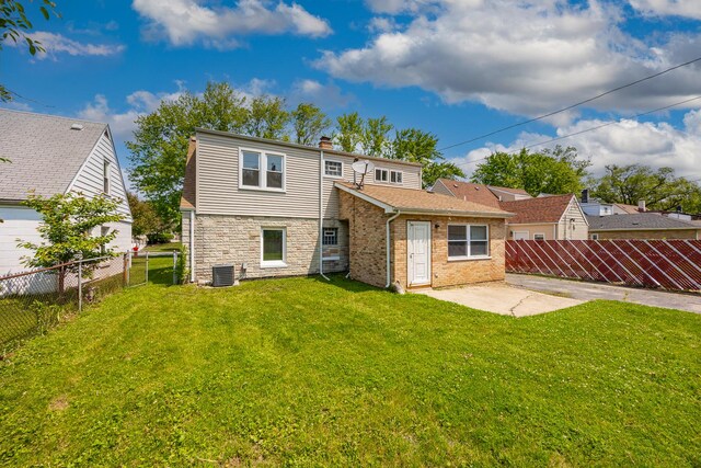4117 W 99th St, Oak Lawn, IL 60453 - back of property with central AC unit, a chimney, a patio, and stone siding
