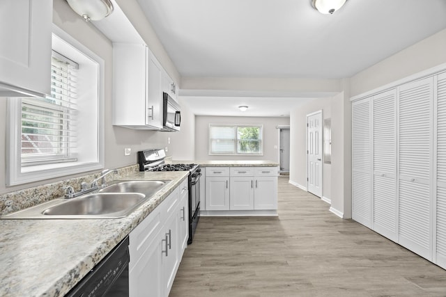 4117 W 99th St, Oak Lawn, IL 60453 - kitchen with stainless steel appliances, white cabinets, a sink, and light countertops