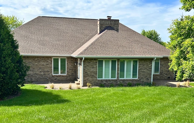 9317 Firth Ct, Lakewood, IL 60014 - rear view of house with a chimney, brick siding, a yard, and a shingled roof