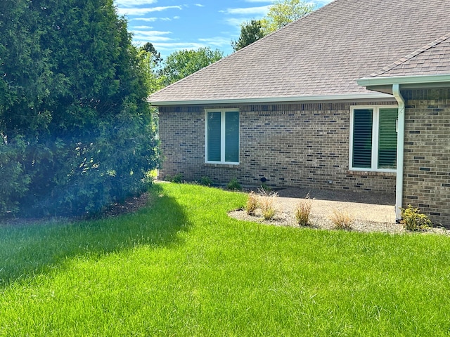9317 Firth Ct, Lakewood, IL 60014 - view of property exterior with roof with shingles, brick siding, a yard, and a patio