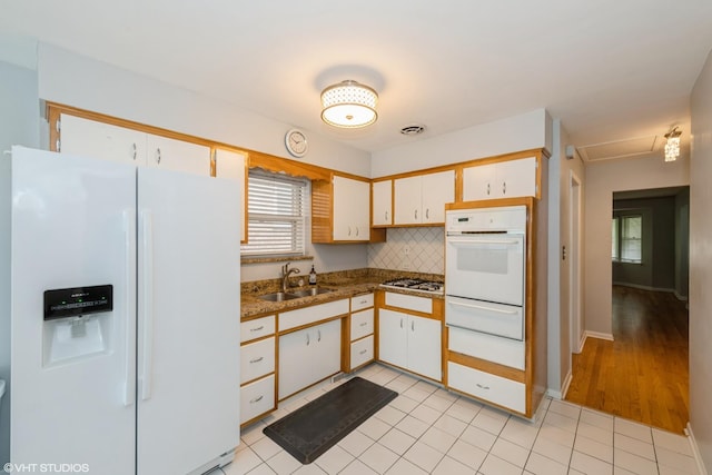3801 S Lombard Ave, Cicero, IL 60804 - kitchen with white appliances, a sink, a warming drawer, and plenty of natural light