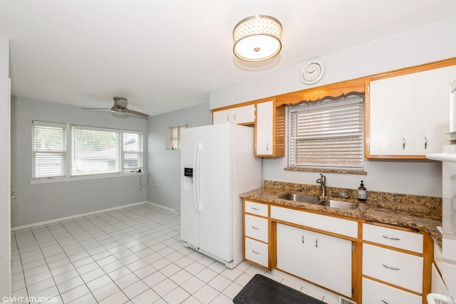 3801 S Lombard Ave, Cicero, IL 60804 - kitchen with white refrigerator with ice dispenser, a sink, ceiling fan, baseboards, and light tile patterned floors