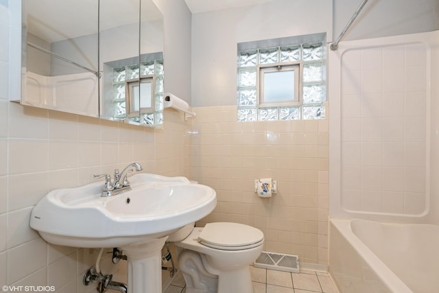 3801 S Lombard Ave, Cicero, IL 60804 - full bathroom with tile walls, tile patterned floors, toilet, and shower / bath combination