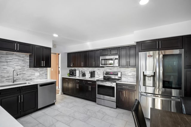 101 Bar Harbour Rd Unit 6E, Schaumburg, IL 60193 - kitchen with appliances with stainless steel finishes, a sink, light marble finish floors, light countertops, and decorative backsplash