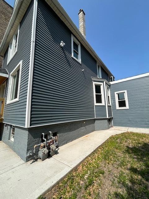 2709 S 59th Ct, Cicero, IL 60804 - view of property exterior with a chimney and a patio area