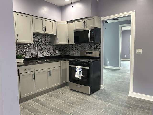 2709 S 59th Ct, Cicero, IL 60804 - kitchen with appliances with stainless steel finishes, wood finish floors, backsplash, and baseboards