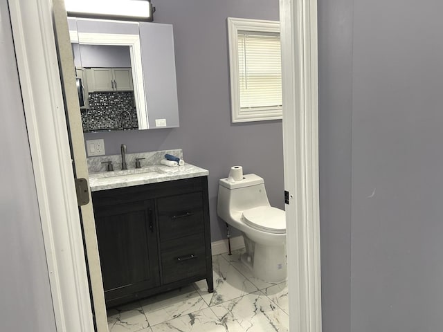 2709 S 59th Ct, Cicero, IL 60804 - bathroom featuring marble finish flooring, vanity, toilet, and baseboards