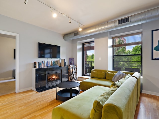 4537 S Drexel Blvd Unit 303, Chicago, IL 60653 - living area featuring track lighting, a fireplace, wood finished floors, and baseboards