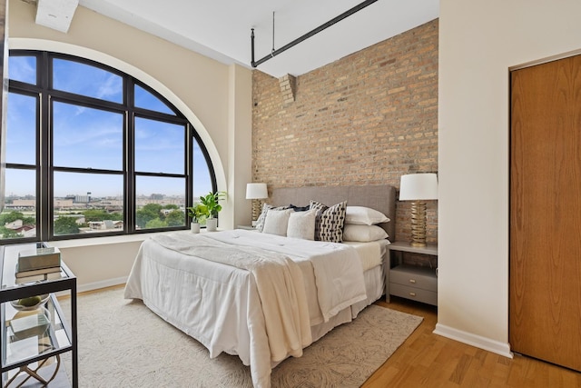 1503 S State St Unit 606, Chicago, IL 60605 - bedroom featuring brick wall and light wood-style floors
