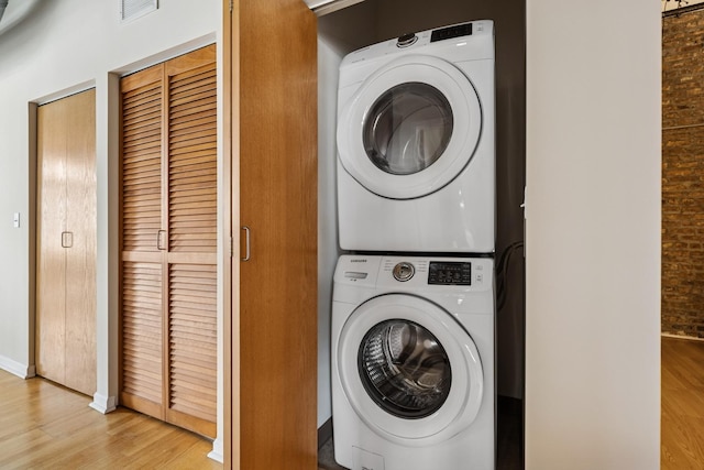 1503 S State St Unit 606, Chicago, IL 60605 - laundry room with stacked washing machine and dryer and light wood-style flooring