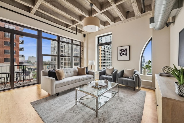 1503 S State St Unit 606, Chicago, IL 60605 - living room with a view of city, light wood-type flooring, and beam ceiling