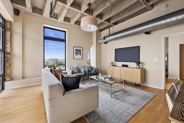 1503 S State St Unit 606, Chicago, IL 60605 - living room featuring wood finished floors, a high ceiling, beam ceiling, and coffered ceiling