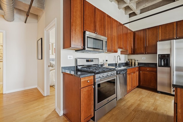 1503 S State St Unit 606, Chicago, IL 60605 - kitchen featuring stainless steel appliances, light wood-style floors, beam ceiling, dark stone countertops, and coffered ceiling