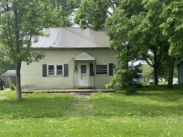 415 W Main St, Arcola, IL 61910 - view of front of home with a front yard and metal roof