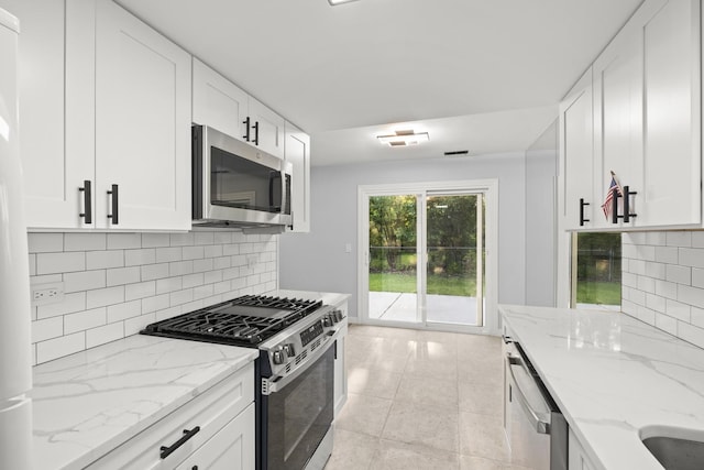4574 Whitney Dr, Hanover Park, IL 60133 - kitchen with stainless steel appliances, decorative backsplash, and white cabinets