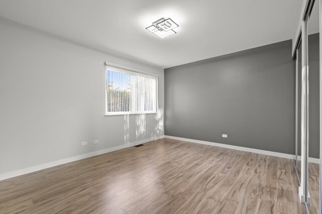 4574 Whitney Dr, Hanover Park, IL 60133 - empty room with light wood-style flooring and baseboards
