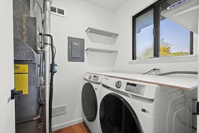 4574 Whitney Dr, Hanover Park, IL 60133 - washroom featuring washer and dryer, wood finished floors, baseboards, and electric panel