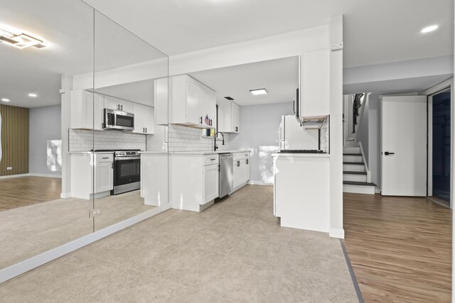 4574 Whitney Dr, Hanover Park, IL 60133 - kitchen with stainless steel appliances, baseboards, backsplash, white cabinets, and a sink