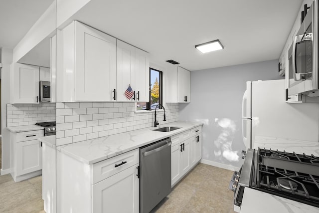 4574 Whitney Dr, Hanover Park, IL 60133 - kitchen featuring stainless steel appliances, a sink, backsplash, and baseboards