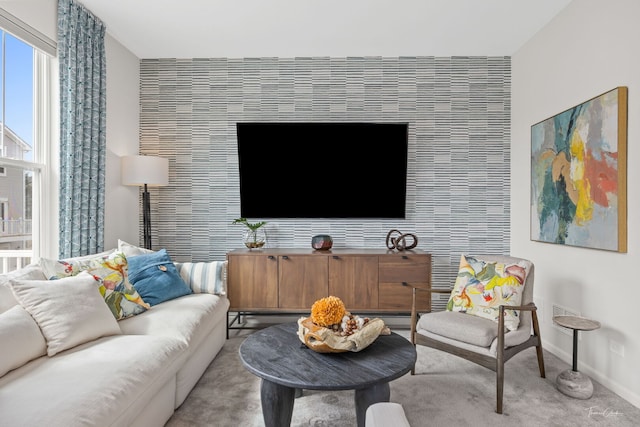 642 Wolverine Dr, Aurora, IL 60502 - living room featuring an accent wall, baseboards, and carpet flooring