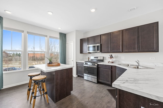642 Wolverine Dr, Aurora, IL 60502 - kitchen with appliances with stainless steel finishes, a sink, dark brown cabinets, dark wood finished floors, and recessed lighting