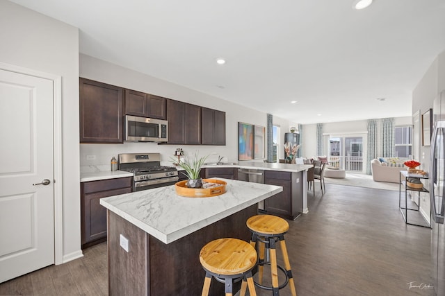 642 Wolverine Dr, Aurora, IL 60502 - kitchen featuring appliances with stainless steel finishes, a peninsula, open floor plan, light countertops, and recessed lighting