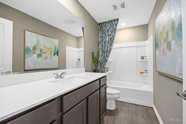 642 Wolverine Dr, Aurora, IL 60502 - bathroom featuring wood finished floors, vanity, toilet, and bathing tub / shower combination