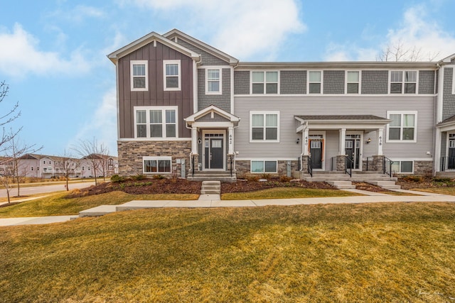 642 Wolverine Dr, Aurora, IL 60502 - view of front of property featuring a front lawn, stone siding, and board and batten siding