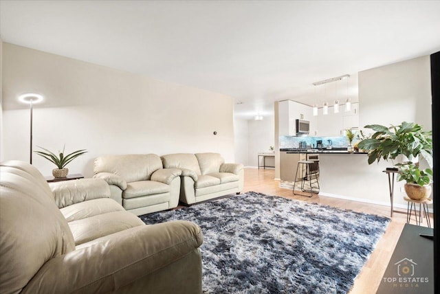 1550 Sandpebble Dr Unit 209, Wheeling, IL 60090 - living area featuring rail lighting and light wood finished floors