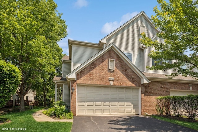 6068 Halloran Ln, Hoffman Estates, IL 60192 - traditional home with driveway, brick siding, and a garage