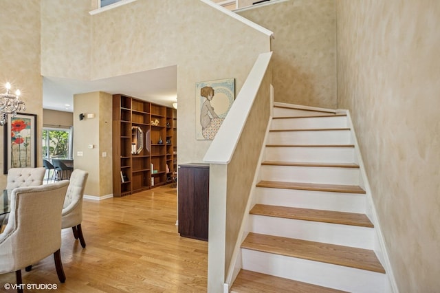 6068 Halloran Ln, Hoffman Estates, IL 60192 - stairs with wood finished floors, a towering ceiling, and baseboards