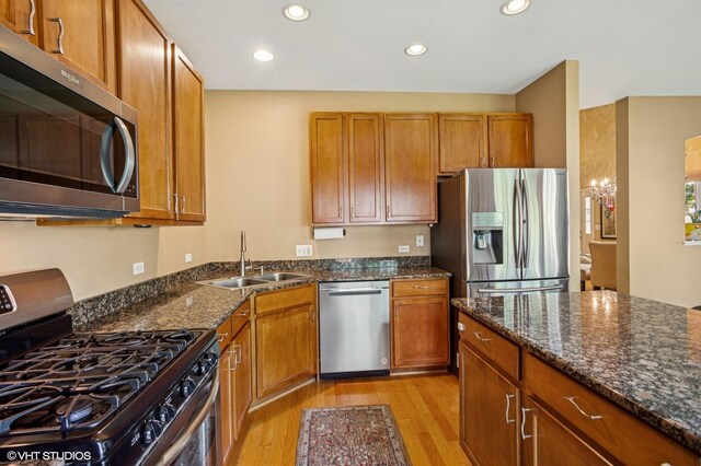 6068 Halloran Ln, Hoffman Estates, IL 60192 - kitchen featuring appliances with stainless steel finishes, a sink, light wood-type flooring, brown cabinetry, and recessed lighting