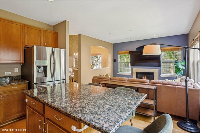 6068 Halloran Ln, Hoffman Estates, IL 60192 - kitchen featuring stainless steel fridge with ice dispenser, light wood-style flooring, open floor plan, and a kitchen island